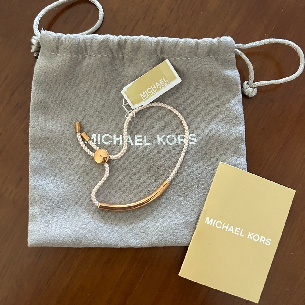 Michael Kors Gold Bar Bracelet w/creamy pinkish rope and sliding gold hardware.